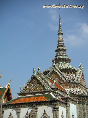A very well decorated silver tower and temple roof.