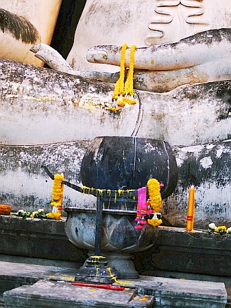An altar in front of a buddha statue.