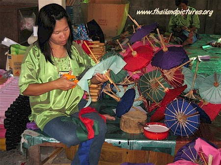 A Thai girl making small umbrellas in a factory.